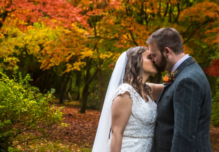 Bride & groom kissing autumn